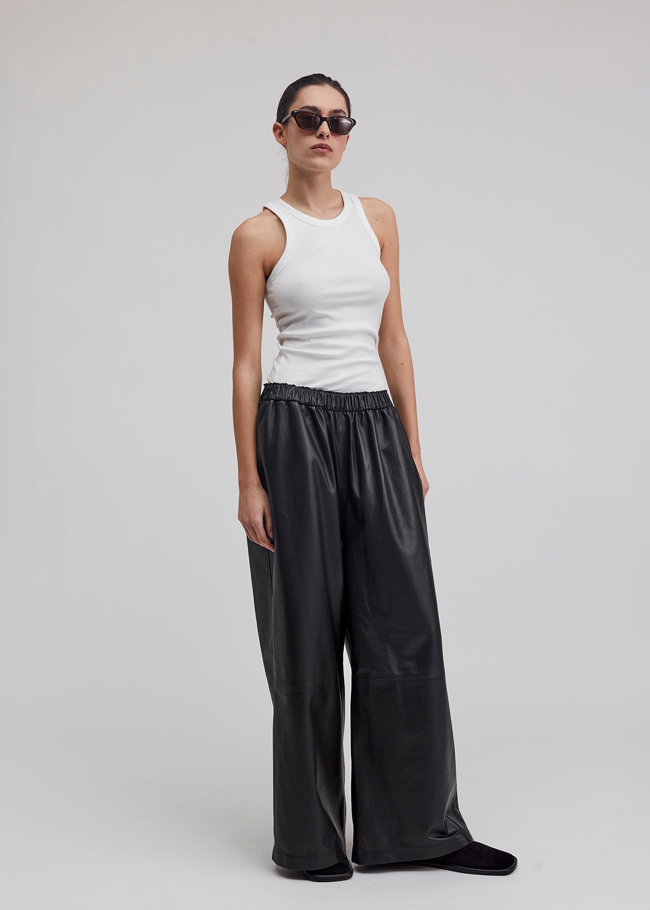13543 PABLO UTZON aw24 black lamb leather pants styled with a white tanktop and sunglasses front