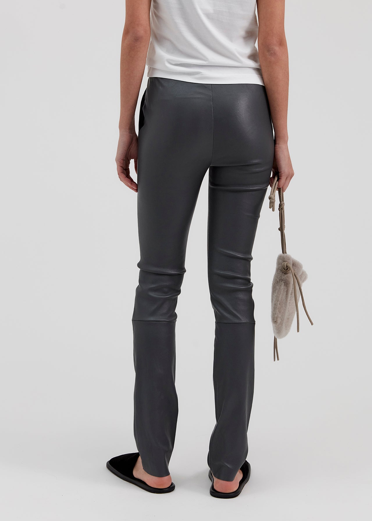 13546 PALMER UTZON aw24 elastic lamb leather pants styled with a white tshirt and black slippers model shown from the back