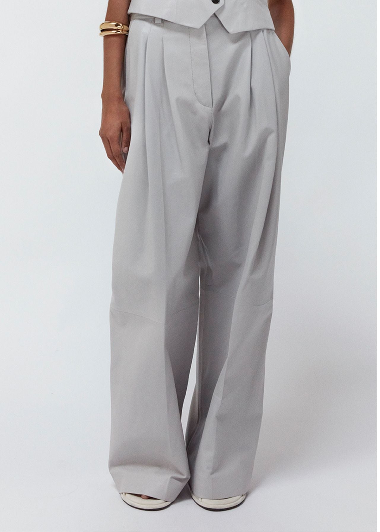 13547 PORTLYN UTZON aw 24 lamb leather pants with wide legs styled with a matching vest and a gold bracelet model shown from the front