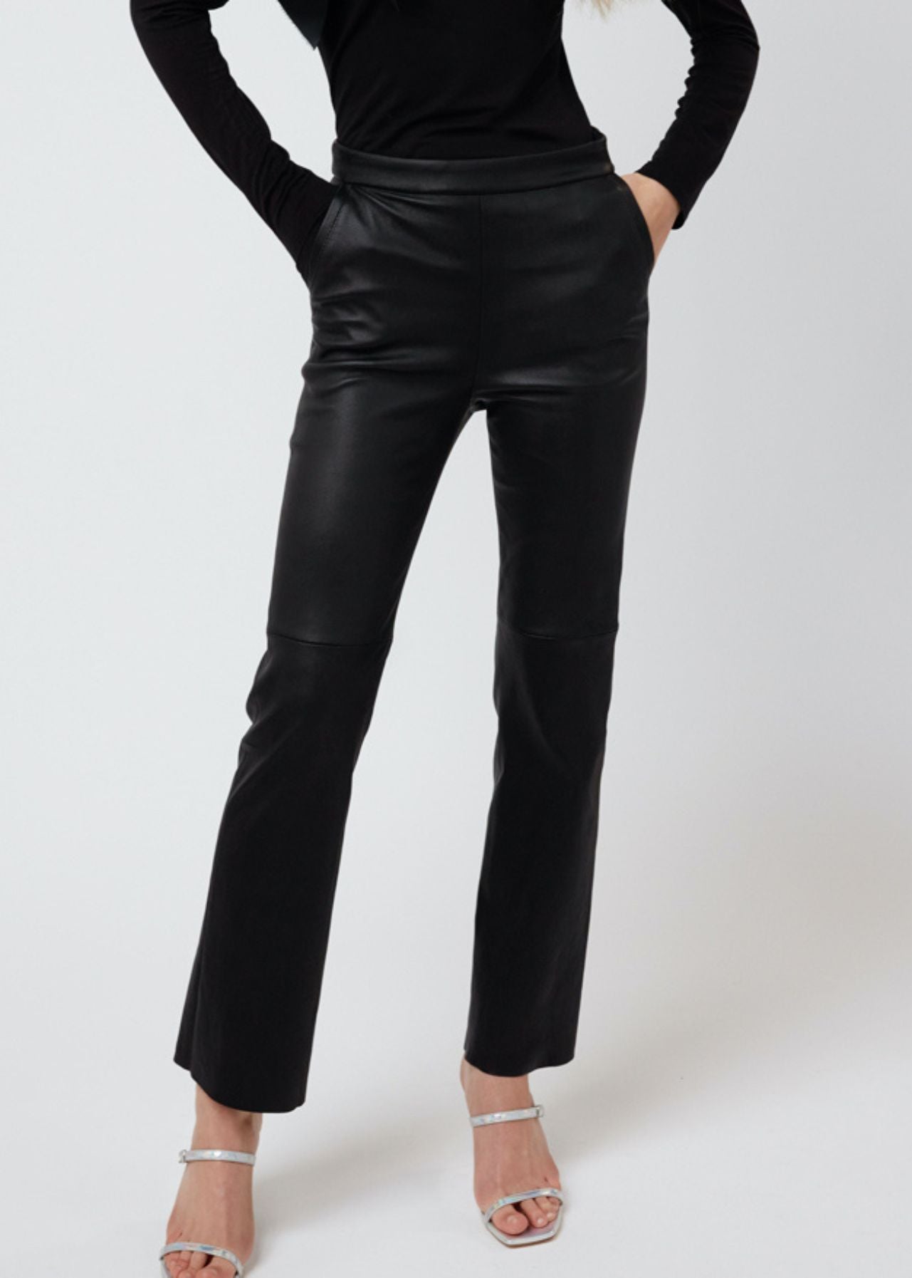 13512 LAVENDER UTZON aw24 black elastic lamb leggings styled with a black top with open shoulders, heels and a bow front close up legs