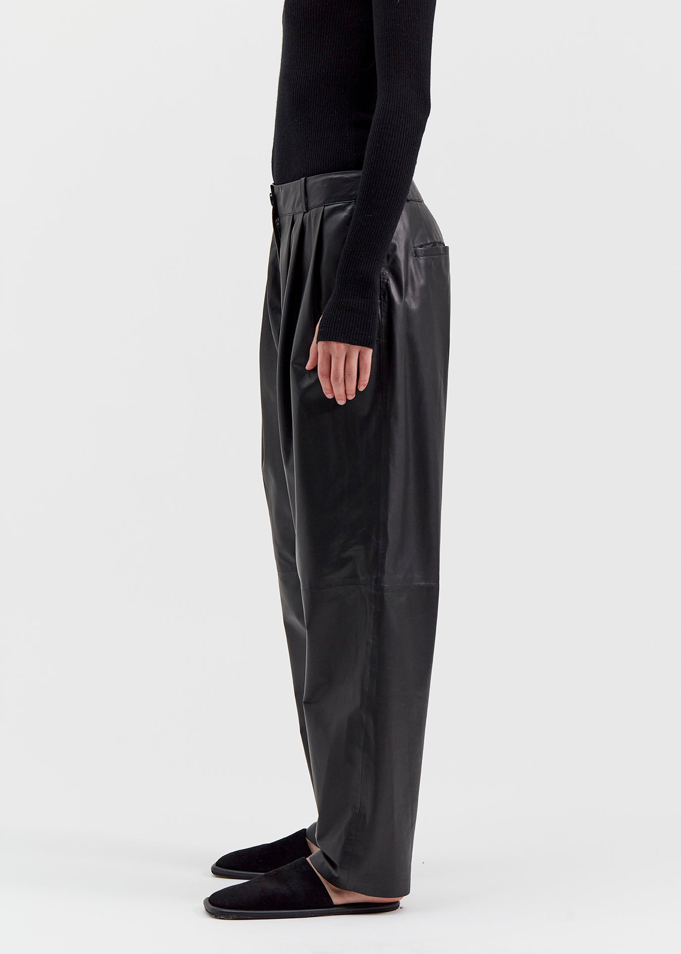 13542 PETER UTZON aw24 black lamb leather pants styled with a black top and black slippers close up of legs side