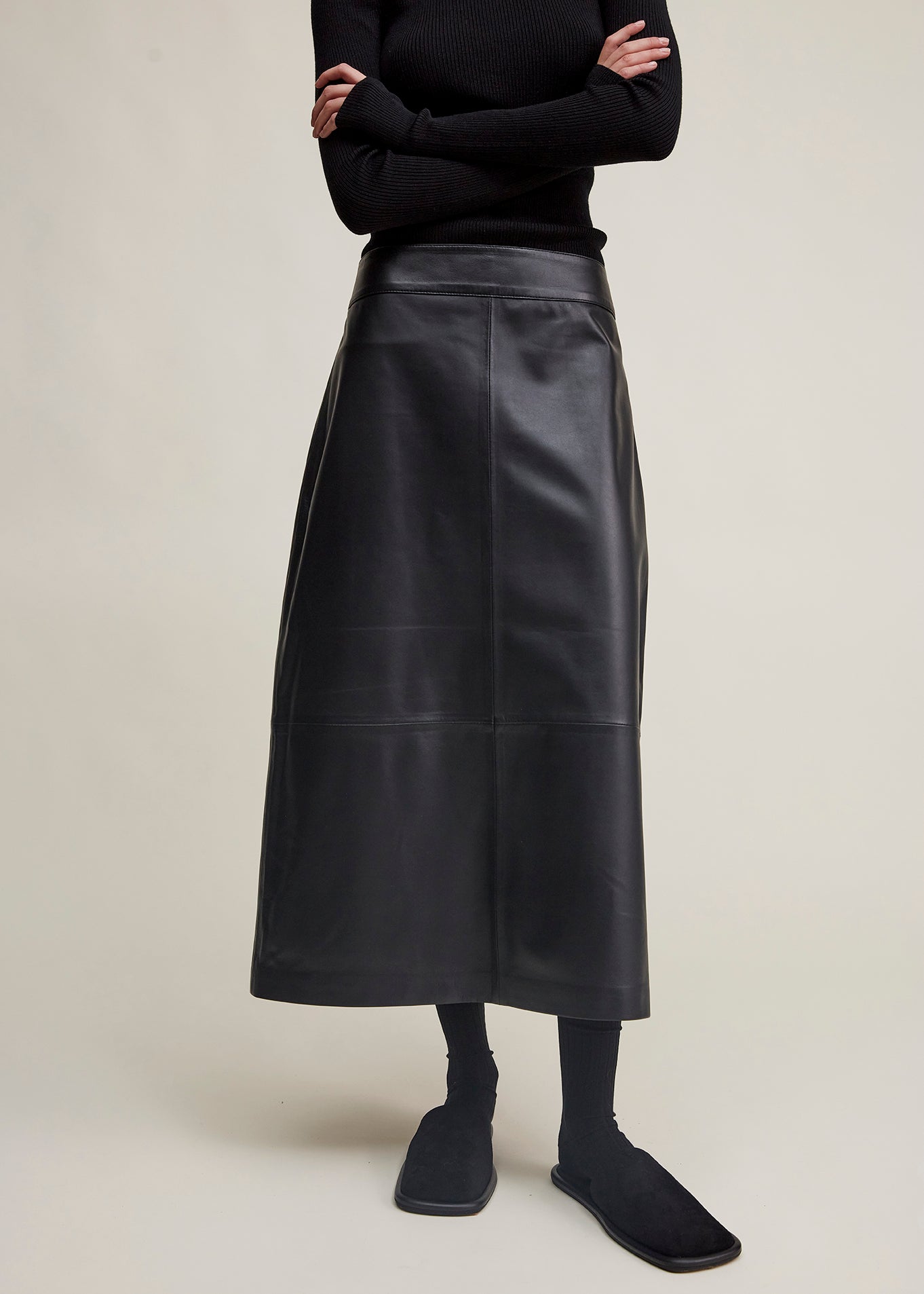 14424 NOAH UTZON aw24 black lamb leather nappa dragon skirt styled with a black top and black slippers model shown from the front not showing head